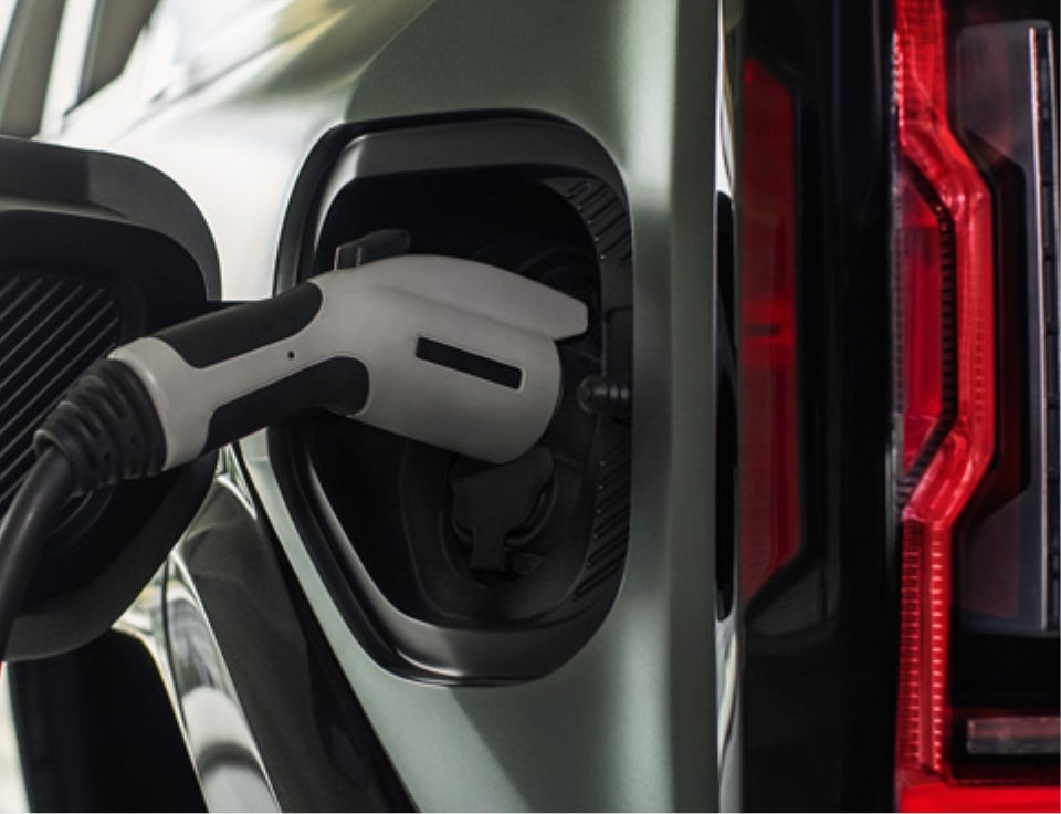 Close up of charging port with charger plugged in on a GMC Hummer EV SUV - Riverhead GMC in Riverhead NY